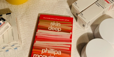 The book Skin Deep is surrounded by medications for psoriasis